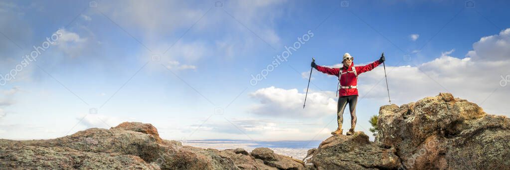 hiker enjoying reaching mountain top