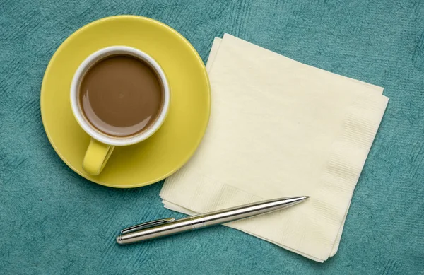 Cup of coffee, napkin and pen flat lay — Stock Photo, Image