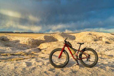 mountain fat bike in badlands with storm clouds in background - Main Draw OHV Area in National Pawnee Grassland in Colorado clipart