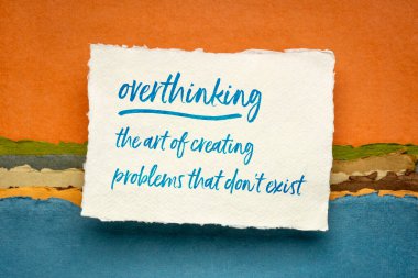 overthinking - the art of creating problems that do not exist - handwriting on a handmade rag paper against abstract landscape, procrastination and personal development concept clipart