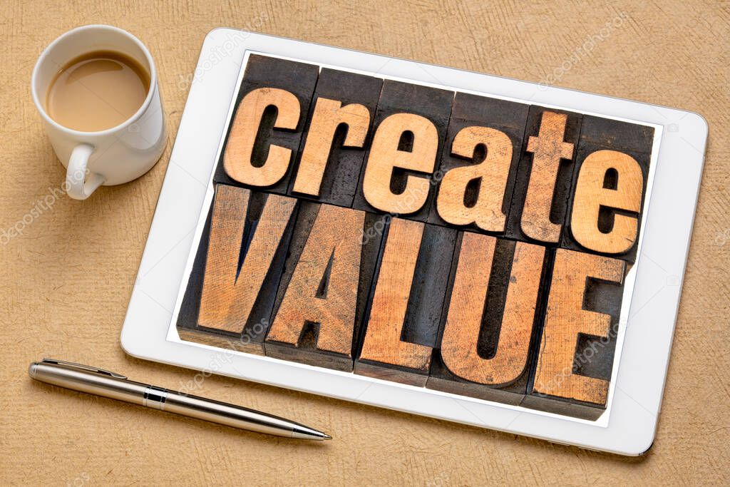 create value typography - words in vintage letterpress wood type blocks on a digital tablet, inspiration, creativity and business  concept