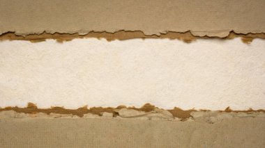 paper abstract in earth tones  with a copy space - sheets of bark and cotton rag paper, blank web banner clipart
