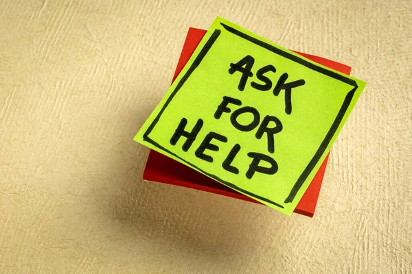 Ask for help advice or reminder - handwriting on a sticky note against textured paper, business, education and teamwork concept