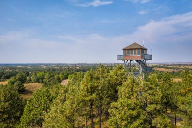 lookout tower in Nebraska National Forest, aerial view of early fall scenery, travel concept clipart