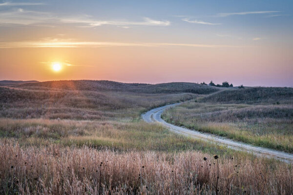 туманный восход солнца над Небраской Sandhills с грязной песчаной дороге в Небраске Национальный лес, осенний пейзаж пострадавших от лесного пожара дыма из Колорадо и Вайоминга