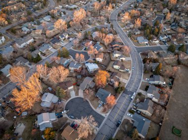 winter morning over a residential street in Fort Collins in northern Colorado, aerial view clipart