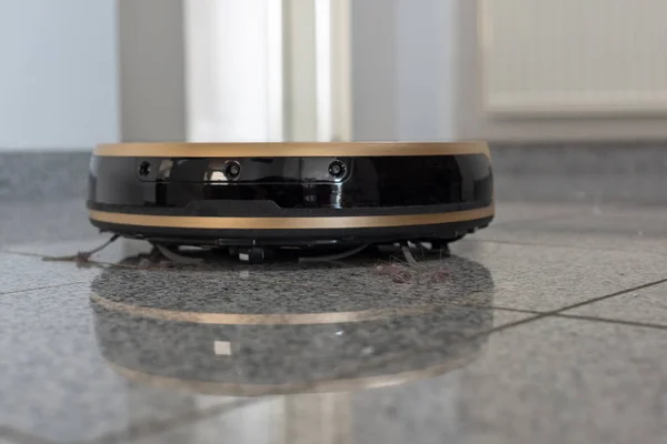 Robotic vacuum cleaner on bright marble floor — Stock Photo, Image