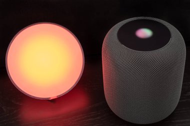 Using an Apple HomePod speaker to control a smart light clipart