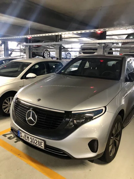 A silver Mercedes-Benz EQC 1886 special edition car is parked in a parking garage in Stuttgart — Stock Photo, Image