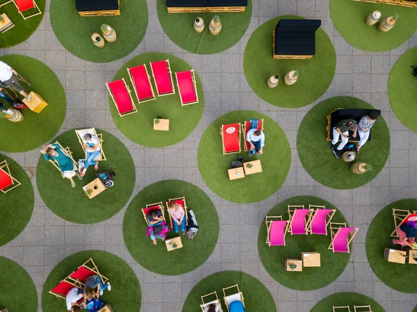 Aerial of people enjoying an open air concert of the Stuttgart Chamber Orchestra during the Kastellsommer in the Roemerkastell in Stuttgart, Germany - due to the Corona Pandemic, social distancing — Stock Photo, Image