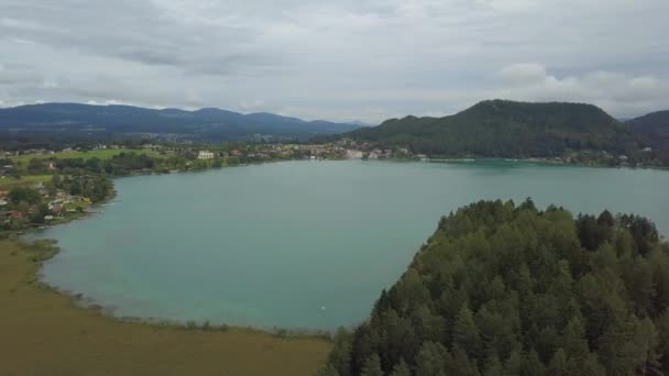 Flygfoto över de övre ändarna av Ossiacher Lake i Kärnten, Österrike på en sommardag med stora molnlandskap — Stockvideo