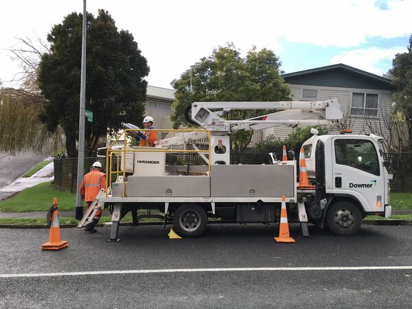 AUCKLAND, JUL. 7:  Cherry picker truck with electrical contractors or electricians working on the side of the road in Auckland, New Zealand taken on Jul. 7, 2017.