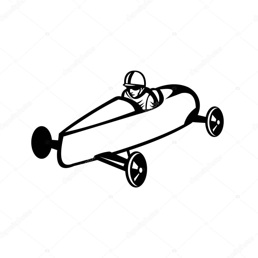 Retro black and white style illustration of a soap box derby or soapbox car racer racing in competition viewed from side on high angle on isolated white background.