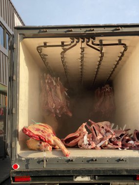 Photo of a  reefer truck, reefer van, reefer trailer, refrigerated van, refrigerated truck or refrigerator truck with halal frozen mutton, beef, goat meat, lamb meat, lamb, hogget or sheep meat. clipart