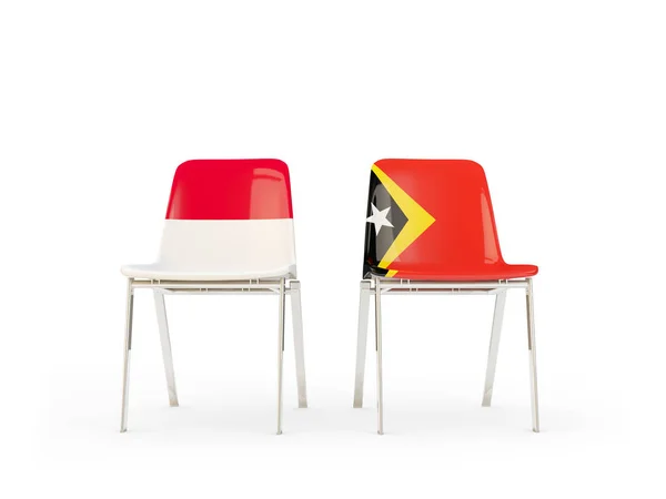 Duas cadeiras com bandeiras da Indonésia e timor leste — Fotografia de Stock