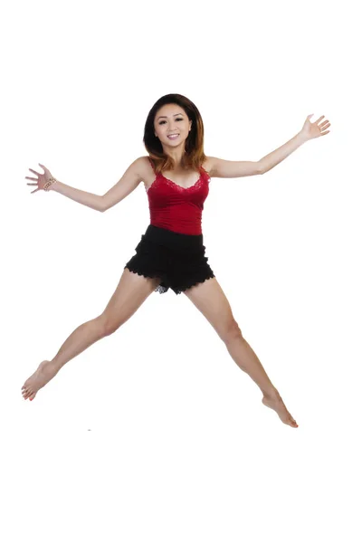 Asian American Woman Jumping Against White Background — Stock Photo, Image