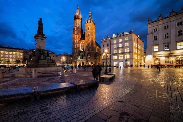 ポーランド アダム ミツキェヴィチ記念碑と聖メアリー大聖堂夕暮れ市クラクフの旧市街の中央広場 — ストック写真