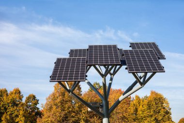 Solar panels on a stand in city park, photovoltaic modules, sustainable renewable energy source clipart