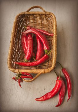 Gri masadaki sepetin içinde kırmızı biber kabukları. Düz yatıyordu. Retro tonlama