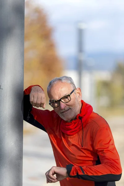 Handsome middle aged man in sports uniform looking at camera and smiling — Stock Photo, Image