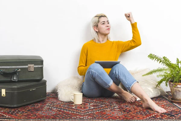 Woman Yellow Sweater Exhibits Triumphant Gesture While Holding Tablet Suggesting Stock Picture