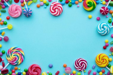 Colorful candies on a blue background clipart