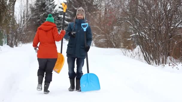 Ein Lustiges Paar Freizeitkleidung Tanzt Mit Schneeschaufeln Auf Einer Verschneiten — Stockvideo