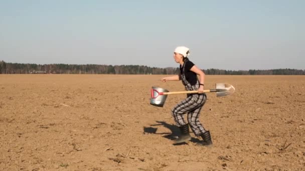 Funny Adult Woman Farmer Shovel Bucket Jumps Freshly Plowed Field — Stock Video