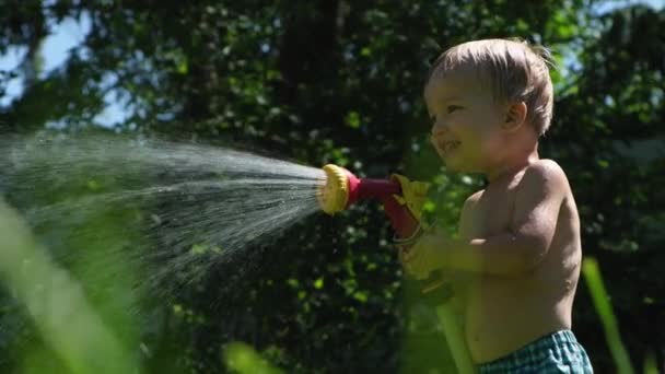 Cute Toddler Blond Boy Playing Garden Sprinkler Summer Hot Day — Stock Video