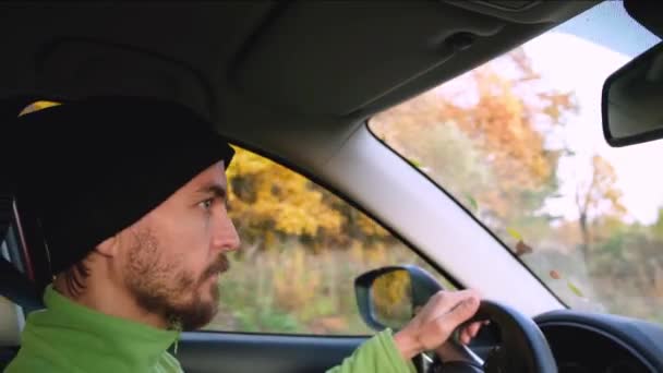Young Caucasian Bearded Man Knitted Hat Drives Car Autumn Rural — Stock Video