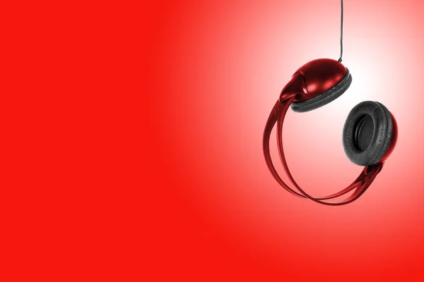 Red headphones on a red background — Stock Photo, Image