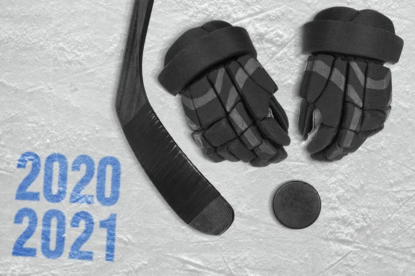 A fragment of a hockey rink, gloves, hockey stick and puck. Concept, hockey season