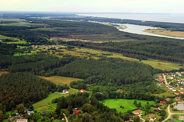 Aerial view over countryside in Latvia near Riga and Gulf of Riga