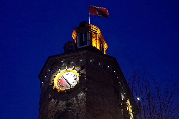 Old fire tower with clock at night in Vinnytsia, Ukraine