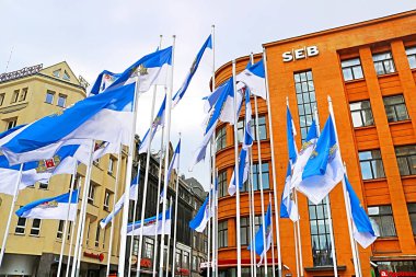 Riga, Letonya - 28 Ağustos 2018: Kalku caddesinde Seb Bank binası ve Riga şehrinin bayrakları