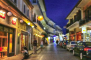 Geceleri küçük bir tatil köyünde otel ve restoranları olan tipik dar sokaklar. Bulanık resim