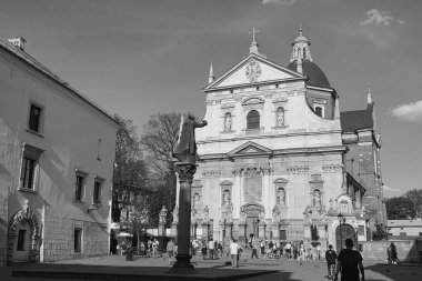 Krakow, Poland - April 23, 2025: View on Church of Saints Peter and Paul and monument of Piotr Skarga. Black and white