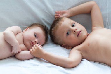 Bir yaz gününde evde oynarken çocuk ve yeni doğan kız