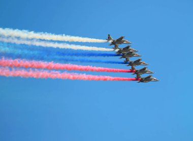 MOSCOW MAI 9 Russian attack aircraft leave multi colored vapor trail of the Russian tricolor  in a flight at the Victory Parade  on Mai 9, 2018 in Moscow clipart