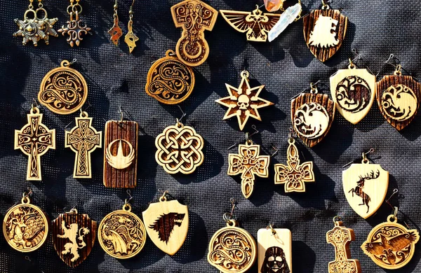 Handmade wooden souvenir crafts with the image of ancient signs and symbols
