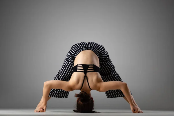 caucasian woman exercising yoga poses, studio shot