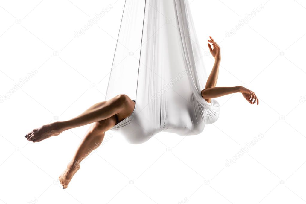 female posing aerial anti-gravity yoga on a hammock 