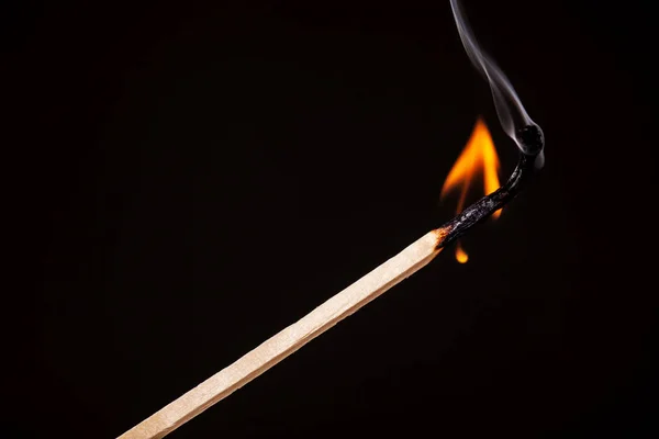 Matchstick burning against black — Stock Photo, Image