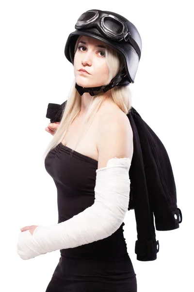 Girl with a broken arm in plaster, wearing motorcycle helmet — Stock Photo, Image
