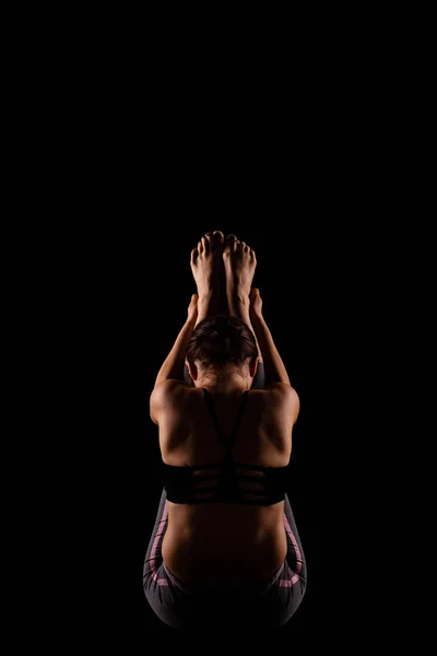 Girl in shadows exercising yoga — Stock Photo, Image