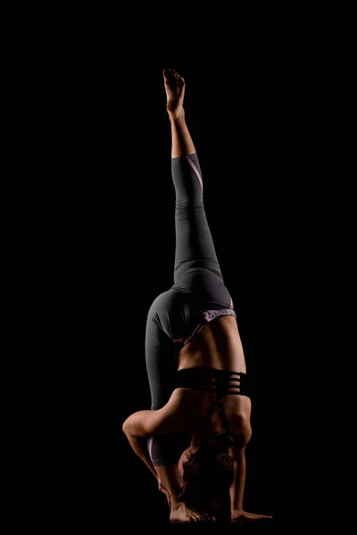 Girl in shadows exercising yoga — Stock Photo, Image