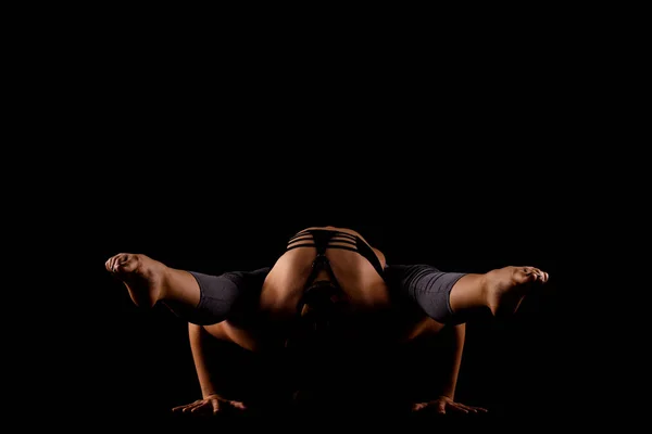 Girl in shadows exercising yoga Stock Image
