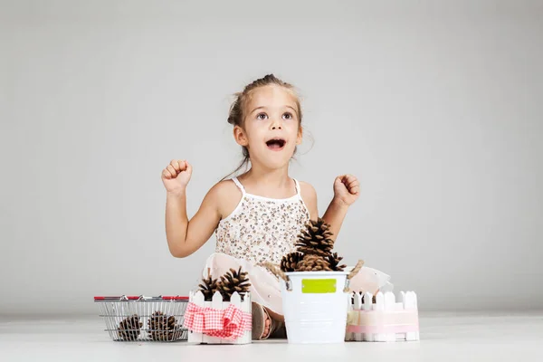 Pequena Menina Caucasiana Brincando Com Pinhas — Fotografia de Stock