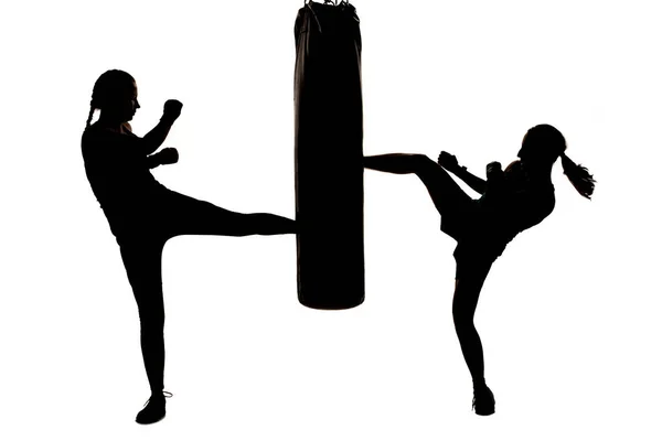 Two Silhouette Kick Fighter Girls Punching Boxing Bag — Stock Photo, Image