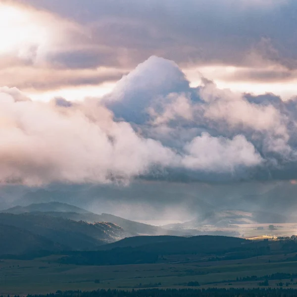 Beautiful landscape, with sun rays through the clouds over mount